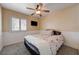 Bedroom with gray carpet, ceiling fan, and shuttered window at 839 Benita Pl, Boulder City, NV 89005
