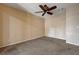 Neutral carpeted bedroom featuring a ceiling fan and ready for personal touches at 839 Benita Pl, Boulder City, NV 89005