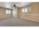 Bedroom featuring carpet, white trim, neutral walls, two windows with plantation shutters, and a closet with doors at 839 Benita Pl, Boulder City, NV 89005