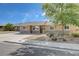 Charming single-story home featuring stone accents, a well-maintained yard, and a long, private driveway at 839 Benita Pl, Boulder City, NV 89005
