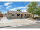 Charming single story home featuring a stone accent wall, lush landscaping, and a spacious driveway at 839 Benita Pl, Boulder City, NV 89005