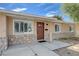 Inviting front entrance with a stylish wood door, stone accents, and a cozy covered porch area at 839 Benita Pl, Boulder City, NV 89005