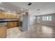 Kitchen with stainless steel appliances, wood cabinets, dark counters, tile floors and view to the front door at 839 Benita Pl, Boulder City, NV 89005