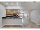 Kitchen with granite counters, stainless appliances, wood cabinets and tile floors and view to connected room at 839 Benita Pl, Boulder City, NV 89005