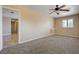 Neutral living room features carpet flooring, neutral paint, and a ceiling fan at 839 Benita Pl, Boulder City, NV 89005