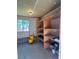 Storage area with block wall foundation, open wood shelving and an exterior window at 839 Benita Pl, Boulder City, NV 89005
