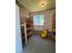 Storage area with block wall foundation, open wood shelving and an exterior window at 839 Benita Pl, Boulder City, NV 89005