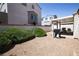 Backyard with covered patio, grill, and manicured landscape, creating a delightful outdoor space at 8437 Cinnamon Hill Ave, Las Vegas, NV 89129