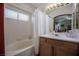 Bathroom featuring a bath/shower combo, single sink vanity, and ample natural light from a window at 8437 Cinnamon Hill Ave, Las Vegas, NV 89129