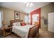 Comfortable bedroom featuring an arched entryway to the bathroom, neutral walls, and a wood bed at 8437 Cinnamon Hill Ave, Las Vegas, NV 89129