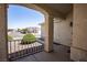 Inviting covered front porch with a cozy seating area and decorative wrought iron railing at 8437 Cinnamon Hill Ave, Las Vegas, NV 89129