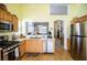 Well-lit kitchen with stainless steel appliances, wood cabinets, and a pass-through to the living area at 8437 Cinnamon Hill Ave, Las Vegas, NV 89129