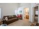 Inviting living room showcasing high ceilings, natural light, a comfortable couch, and access to the bathroom at 8437 Cinnamon Hill Ave, Las Vegas, NV 89129