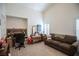 A versatile living space with a sofa, desk, and shuttered windows, perfect for work or relaxation at 8437 Cinnamon Hill Ave, Las Vegas, NV 89129