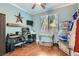 This bedroom is styled as a home office, featuring a desk, a gaming setup, and wood-look floors at 9192 Moose Country Pl, Las Vegas, NV 89178