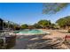 Large community pool with plenty of lounge chairs and mature trees, creating a perfect oasis at 9192 Moose Country Pl, Las Vegas, NV 89178