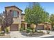 Charming two-story home featuring a well-manicured front yard and two-car garage at 9192 Moose Country Pl, Las Vegas, NV 89178