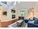 Bright living room featuring a fireplace, hardwood floors and large window at 9192 Moose Country Pl, Las Vegas, NV 89178