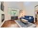 Bright living room featuring a fireplace, hardwood floors and large window at 9192 Moose Country Pl, Las Vegas, NV 89178
