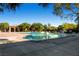 Community swimming pool featuring a building for relaxing and mature trees at 9192 Moose Country Pl, Las Vegas, NV 89178