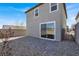 A backyard featuring a sliding glass door, a rock garden, and a stone tile patio at 9330 Brookmont Ave, Las Vegas, NV 89149