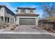 Two-story home featuring a tile roof, paired garage, and neat landscaping, presenting a well-kept exterior at 9330 Brookmont Ave, Las Vegas, NV 89149