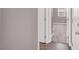 Hallway leading to carpeted bedroom with white trim, showcasing the home's neutral color palette at 9330 Brookmont Ave, Las Vegas, NV 89149