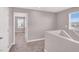 Upstairs hallway with neutral carpet and white trim at 9330 Brookmont Ave, Las Vegas, NV 89149