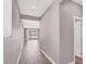 Inviting hallway with wood-look flooring, neutral paint, and natural light, leading to an open living space at 9330 Brookmont Ave, Las Vegas, NV 89149