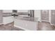 Contemporary kitchen island with granite countertops, white cabinets, and stainless steel appliances, perfect for modern living at 9330 Brookmont Ave, Las Vegas, NV 89149