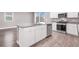 Kitchen island with stainless steel dishwasher, cabinets, and granite countertops at 9330 Brookmont Ave, Las Vegas, NV 89149