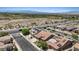 Drone shot of a residential area featuring tidy homes, solar panels, and scenic mountain views at 1008 New Creek Ave, Henderson, NV 89015