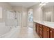Bright primary bathroom with double vanity, soaking tub, and glass shower enclosure at 1008 New Creek Ave, Henderson, NV 89015