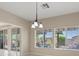 Bright dining area featuring an elegant chandelier and windows with outdoor views at 1008 New Creek Ave, Henderson, NV 89015