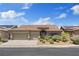 Charming single-story home features a tile roof, desert landscaping, and a spacious three-car garage at 1008 New Creek Ave, Henderson, NV 89015