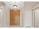 Bright foyer features tile flooring, a pendant light, and double-door closet for storage at 1008 New Creek Ave, Henderson, NV 89015
