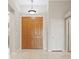 Bright foyer features tile flooring, a pendant light, and double-door closet for storage at 1008 New Creek Ave, Henderson, NV 89015