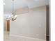 Living room boasts neutral walls, tile flooring, and an elegant chandelier fixture at 1008 New Creek Ave, Henderson, NV 89015