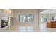 Bright living space offers a cozy fireplace, tile flooring, and large windows with views of the backyard at 1008 New Creek Ave, Henderson, NV 89015
