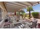 Outdoor patio area with pergola, seating, desert landscape and mature trees at 1008 New Creek Ave, Henderson, NV 89015