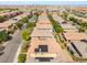 Neighborhood aerial view showcasing a community of single-Gathering homes with solar panels and desert landscaping at 10315 Turia Gardens Rd, Las Vegas, NV 89135