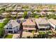 Aerial showcases a home with solar panels, well-maintained landscaping, and a fenced backyard in a suburban setting at 10315 Turia Gardens Rd, Las Vegas, NV 89135