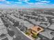 Aerial view of a two-story home with solar panels in a residential neighborhood with views of the surrounding landscape at 10315 Turia Gardens Rd, Las Vegas, NV 89135
