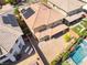 Aerial view showcases the backyard featuring desert landscaping, a patio cover, and an inviting swimming pool at 10315 Turia Gardens Rd, Las Vegas, NV 89135
