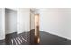 Bright bedroom featuring hardwood floors, white trim, and a door to the walk-in closet at 10315 Turia Gardens Rd, Las Vegas, NV 89135