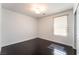 This bedroom features hardwood floors and a window at 10315 Turia Gardens Rd, Las Vegas, NV 89135