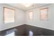 This bedroom features hardwood floors and natural light through the window at 10315 Turia Gardens Rd, Las Vegas, NV 89135