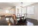 Bright dining room adjacent to living area with modern lighting and large windows at 10315 Turia Gardens Rd, Las Vegas, NV 89135