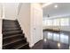 Elegant entryway featuring a staircase with dark wood steps and access to a living area at 10315 Turia Gardens Rd, Las Vegas, NV 89135