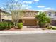 Charming two-story home featuring a paved driveway, a two-car garage and low maintenance landscaping at 10315 Turia Gardens Rd, Las Vegas, NV 89135